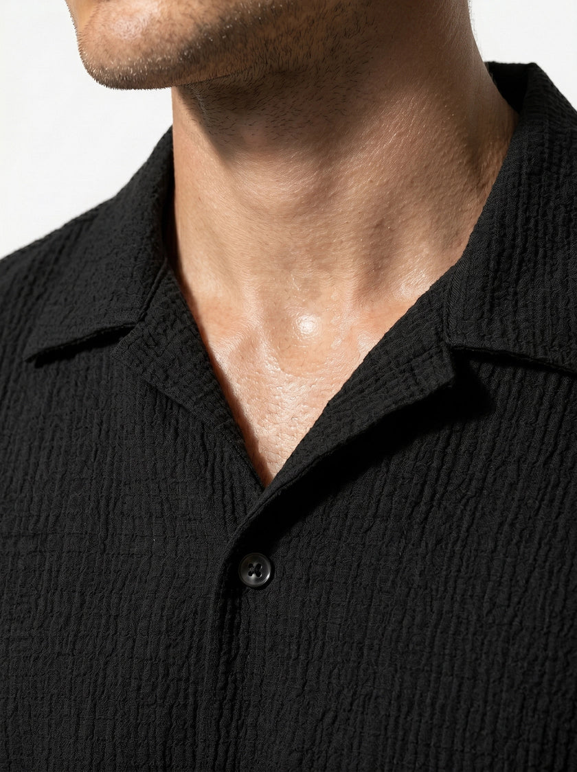 Close-up of FJØRNA men's short sleeve button-up shirt, showcasing the classic casual design and fabric details.