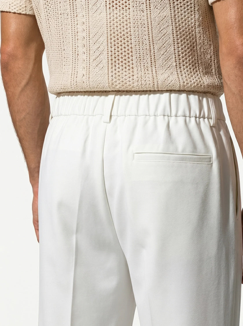 Close-up of FJØRNA men's straight fit tailored trousers showing the fabric texture and classic design details.