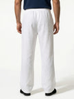 Men's linen trousers by FJØRNA, relaxed fit summer pants, close-up of breathable, lightweight fabric in a 3/4 zoom.