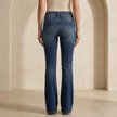 Women’s mid waist slim fit flared jeans by FJØRNA, showing stretch fabric and fashionable silhouette in a casual style.