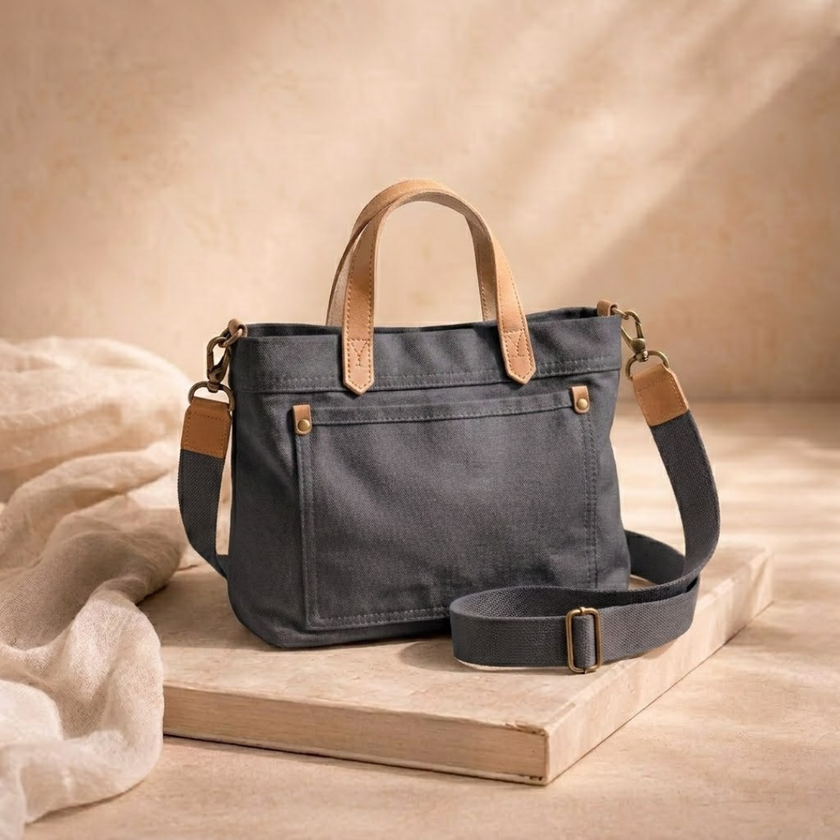 Large FJØRNA canvas messenger bag for women with adjustable strap and spacious interior, casual style for everyday use.