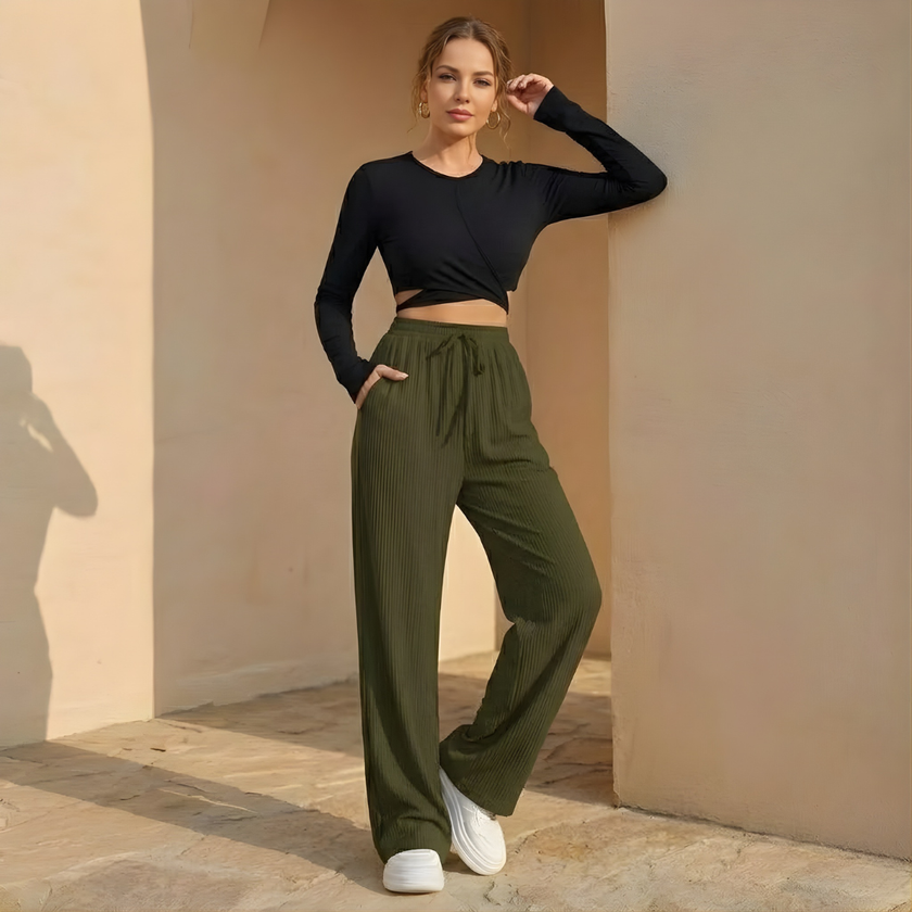 FJØRNA women's wide leg pants with elastic waist and pleated design, featuring a relaxed fit and stylish silhouette.