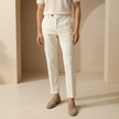 Men's relaxed fit straight leg trousers by FJØRNA, shown in a neutral color, with a tailored waistband and classic pant silhouette.