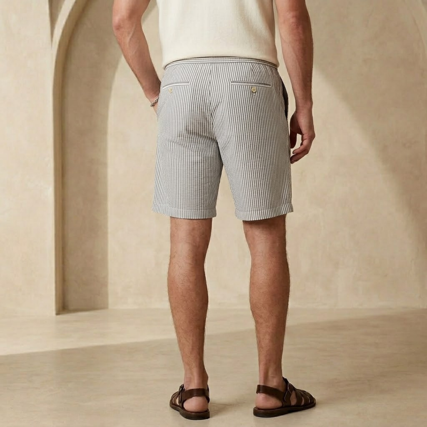 FJØRNA men's relaxed fit drawstring shorts with a casual style, shown in a neutral fabric and comfortable fit.