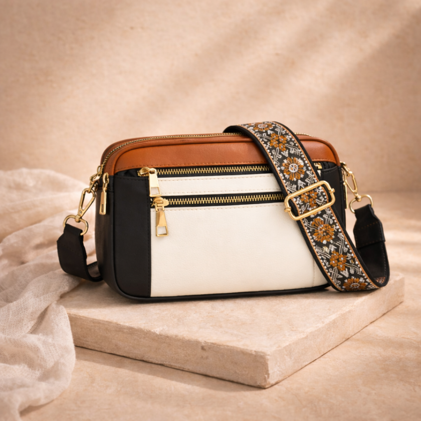 FJØRNA leather shoulder bag for women with sleek design, featuring a smooth leather surface and adjustable strap.