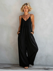 Women’s cotton-linen sleeveless jumpsuit by FJØRNA, loose-fit square neck wide-leg pants, shown hanging on a white background.