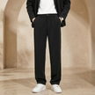 FJØRNA men's pleated relaxed fit trousers, stylish pants with a comfortable fit, shown in a neutral color on a plain background.