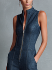 FJØRNA women's dark denim flared jumpsuit with high neck, sleeveless design, and front zipper, styled as pants.