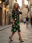 Flowy women's summer dress by FJØRNA featuring a polka dot wrap design, lightweight and perfect for warm weather.