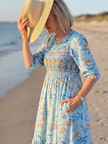 FJØRNA women's summer midi dress with floral pattern, short sleeves, wrap style, and flowy fabric for a breezy, stylish look.