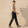 FJØRNA men's high waist straight leg trousers, black pants with a clean fit and tailored look, front and side view.