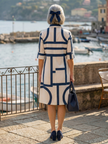 FJØRNA women's summer dress with geometric wrap design, sleeveless style, and vibrant pattern perfect for warm-weather wear.