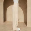 Women’s high-waisted tailored wide-leg trousers from FJØRNA, shown in a stylish fit with smooth fabric and classic design.