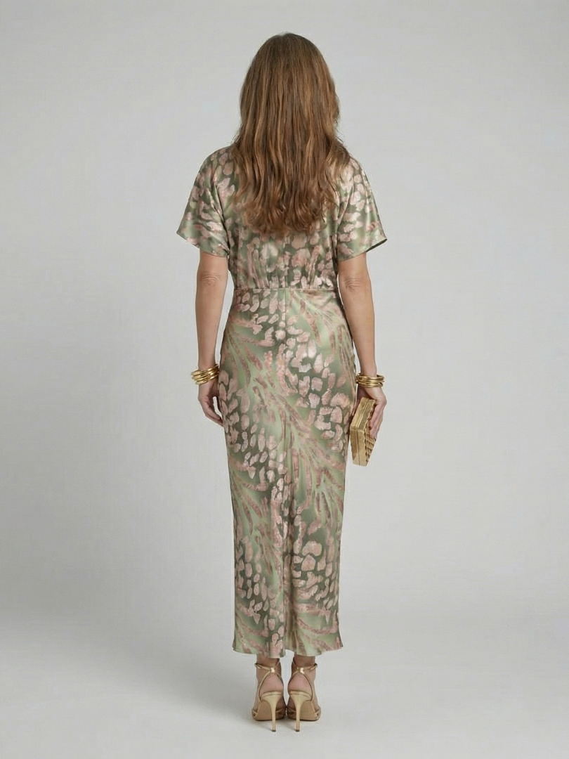 FJØRNA women's summer midi dress with colorful print, short sleeves, and flowing fabric for a stylish warm-weather look.
