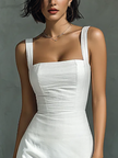 White cotton and linen blend sleeveless women's midi dress by FJØRNA, shown hanging with flowing fabric and simple design.