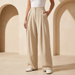 Women's high waisted wide leg tailored trousers by FJØRNA, shown in a sleek, professional fit on a model.