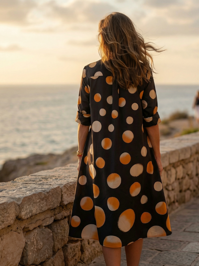 FJØRNA women's polka dot wrap summer dress with short sleeves and V-neck, flowing fabric, perfect for warm weather.