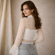 FJØRNA women's lace top with a mock neck, featuring intricate lace details and a stylish fit, perfect for fashionable occasions.