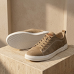 FJØRNA men's suede trainers showing a stylish casual shoe with tan and navy color accents on a white background.