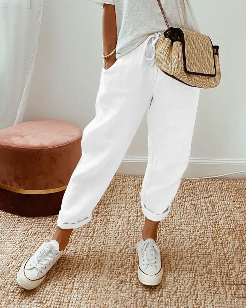 FJØRNA lightweight summer women's trousers with high waist, straight-leg fit, and side pockets, perfect for warm weather.
