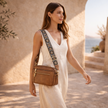 FJØRNA leather shoulder bag for women, stylish and compact with adjustable strap, featuring a smooth leather surface and modern design.