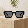 Unisex vintage rectangular sunglasses by FJØRNA with dark tinted lenses and sleek black frame, accessory for women.