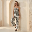 Women’s two-piece suit set by FJØRNA featuring a wide-leg tropical print, stylish and comfortable for warm-weather wear.