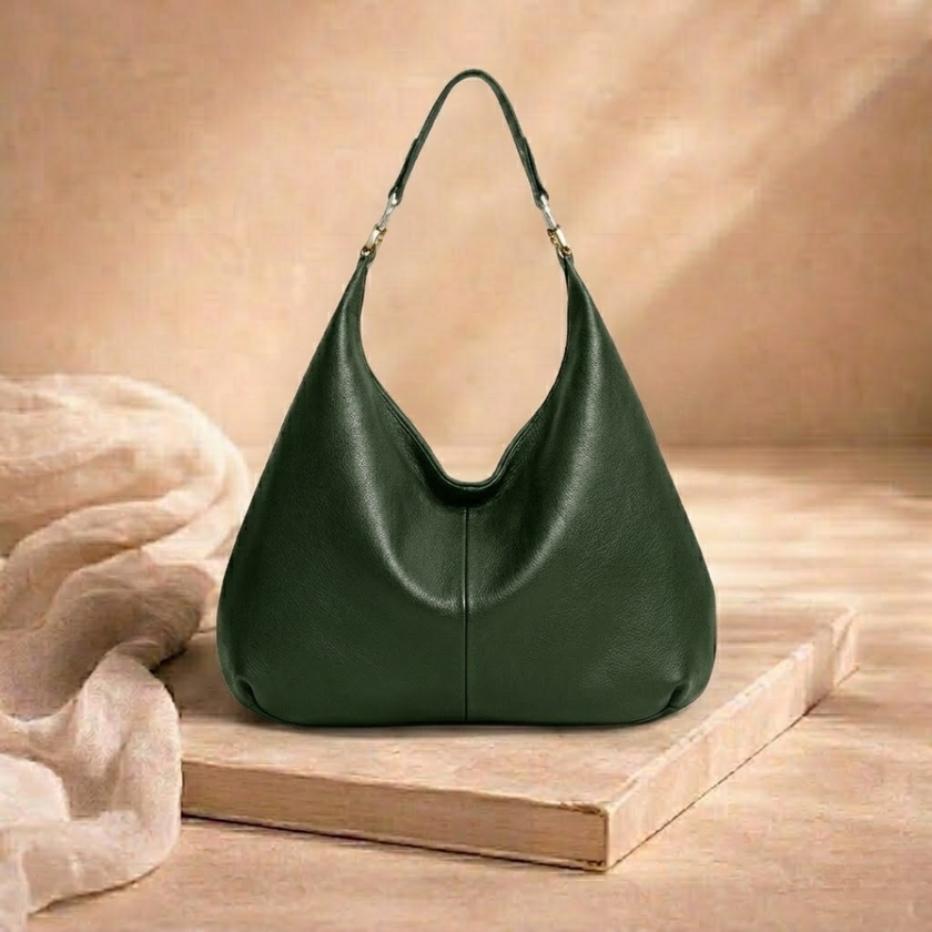 Large FJØRNA leather bag for women with spacious design and stylish appearance, featuring smooth brown leather and sturdy handles.