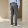 Men's tailored relaxed fit straight leg trousers by FJØRNA, shown in a neutral color with a classic waistband and front pockets.