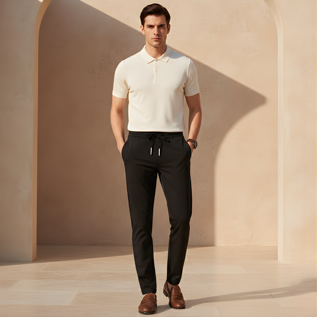 Men's FJØRNA trousers, stylish and comfortable pants with a tailored fit, shown in a neutral color on a plain background.