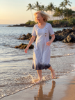 FJØRNA women's summer midi dress with striped pattern, short sleeves, and front pockets, perfect for warm weather.