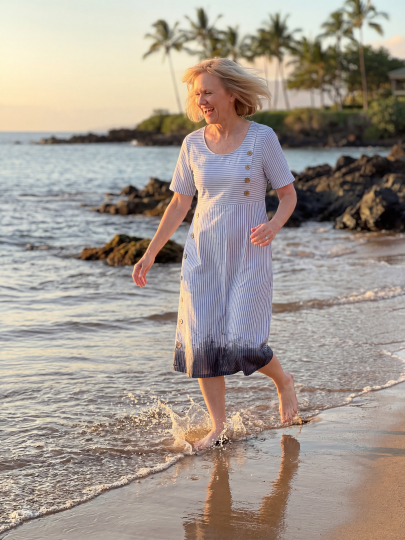 FJØRNA women's summer midi dress with striped pattern, short sleeves, and front pockets, perfect for warm weather.