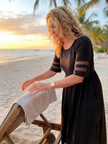 FJØRNA elegant midi wrap dress for women, featuring a sophisticated evening style with flowing fabric and a stylish design.