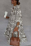 FJØRNA floral printed V-neck bell sleeve mini dress showcasing a vibrant floral pattern and stylish bell sleeves.