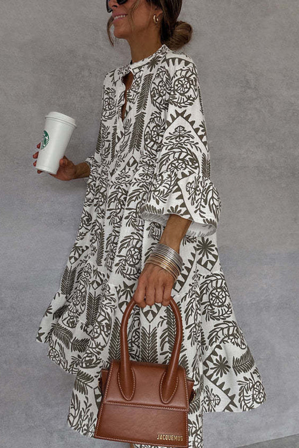 FJØRNA floral printed V-neck bell sleeve mini dress showcasing a vibrant floral pattern and stylish bell sleeves.