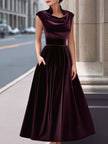 FJØRNA velvet cowl-neck sleeveless evening gown with an A-line silhouette and long sleeves, suitable for formal occasions.