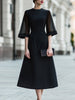 FJØRNA sheer sleeve midi dress with structured waist, elegant design, lightweight fabric, and fitted silhouette.
