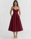 FJØRNA women's corset midi dress with a tulle skirt, featuring a fitted bodice and flowing layered tulle fabric.