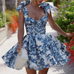 Blue floral off-shoulder mini dress by FJØRNA featuring elegant party wear design and vibrant floral pattern.