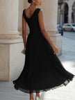 FJØRNA sleeveless pleated midi dress with draped neckline, elegant and flowy women’s dress displayed on a model.