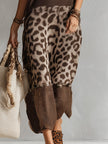 FJØRNA brown knit leopard print maxi dress featuring long sleeves and a flowing silhouette for evening wear.