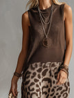 Brown knit leopard print maxi dress by FJØRNA, featuring a flowing silhouette and long sleeves, perfect for evening wear.