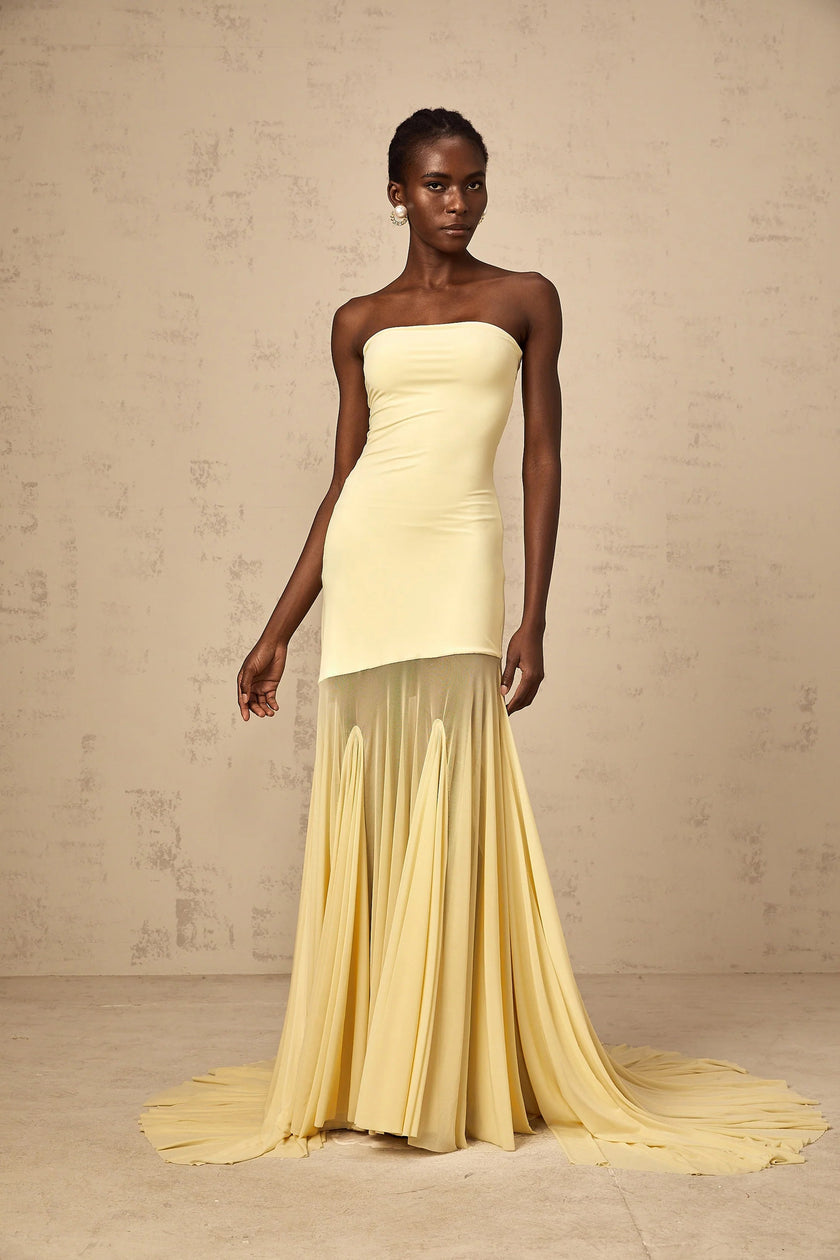 FJØRNA Josiane yellow off-shoulder sheer tulle maxi dress with flowing fabric and romantic design, perfect for elegant occasions.