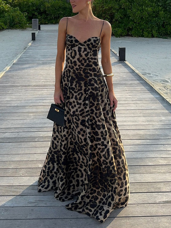 FJØRNA elegant leopard print women's maxi dress with strappy details, flowing fabric, and stylish design for fashionable occasions.