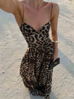 Elegant FJØRNA leopard print maxi dress with strappy details, perfect for stylish occasions and effortless sophistication.