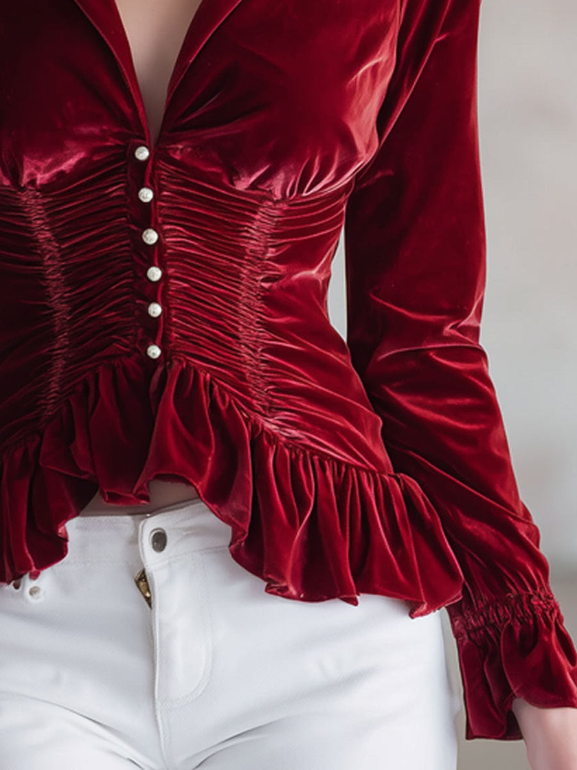 Red velvet pleated ruffled long sleeve blouse by FJØRNA featuring elegant pleats and ruffles in a rich red velvet fabric.