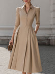 Beige FJØRNA pleated midi dress with shirt collar, sleeveless design, and button-up front, perfect for women’s stylish occasions.