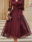 FJØRNA elegant wrap midi dress for women featuring sheer sleeves and a sophisticated design, perfect for formal occasions.