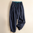 FJØRNA linen tapered trousers for women, stylish and comfortable pants with a relaxed fit, shown in natural fabric and neutral color.