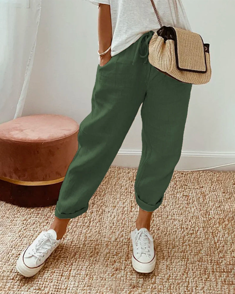 FJØRNA lightweight women's summer trousers with high waist, straight leg fit, and front pockets, shown in a neutral color.
